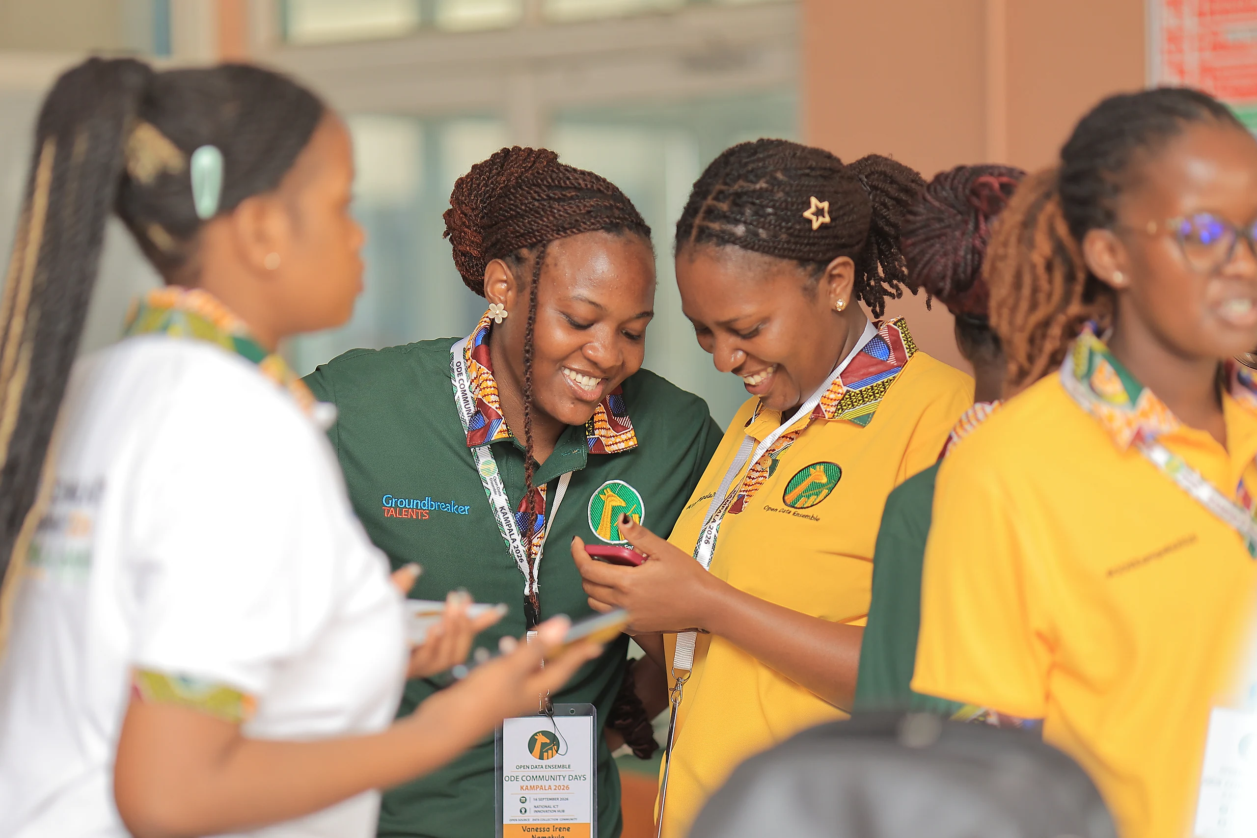 Participants laugh together over a phone as the day begins.
