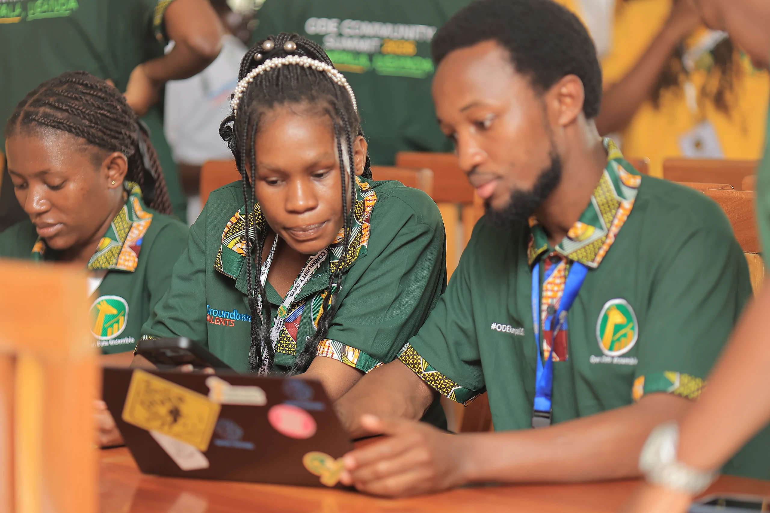 Three participants explore ODE together on a shared laptop.