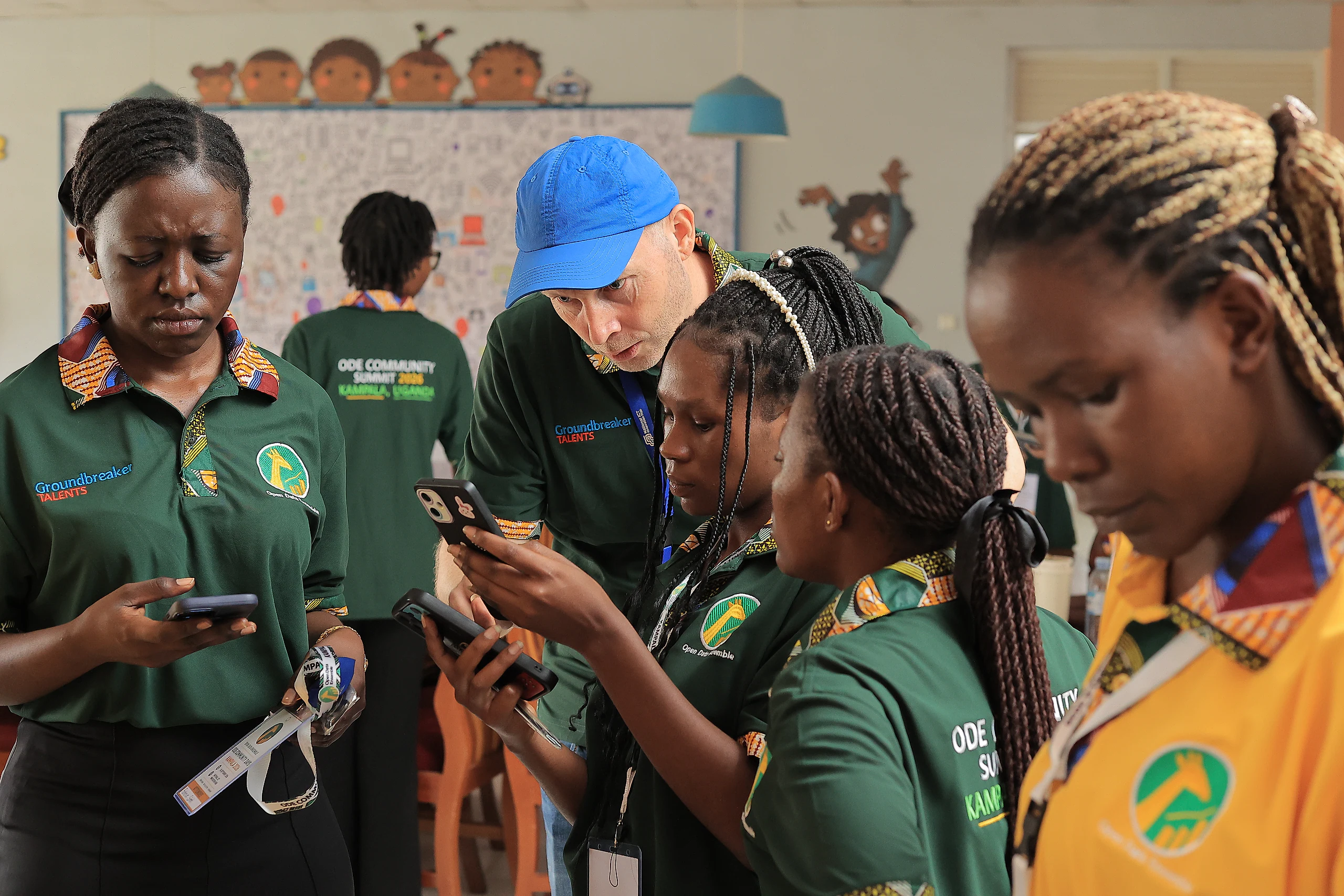 A facilitator guides a group as they try forms on their phones.
