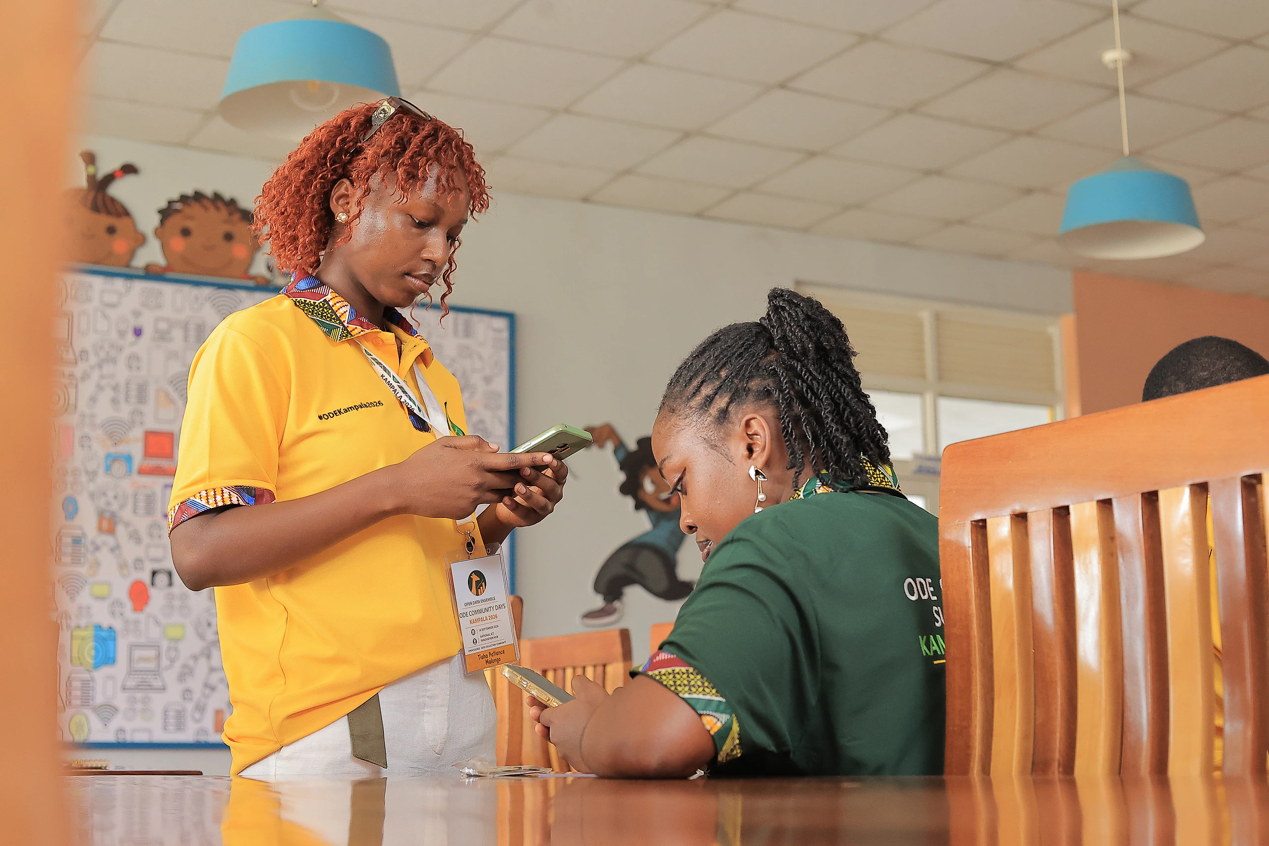 Two participants check something on a phone together.