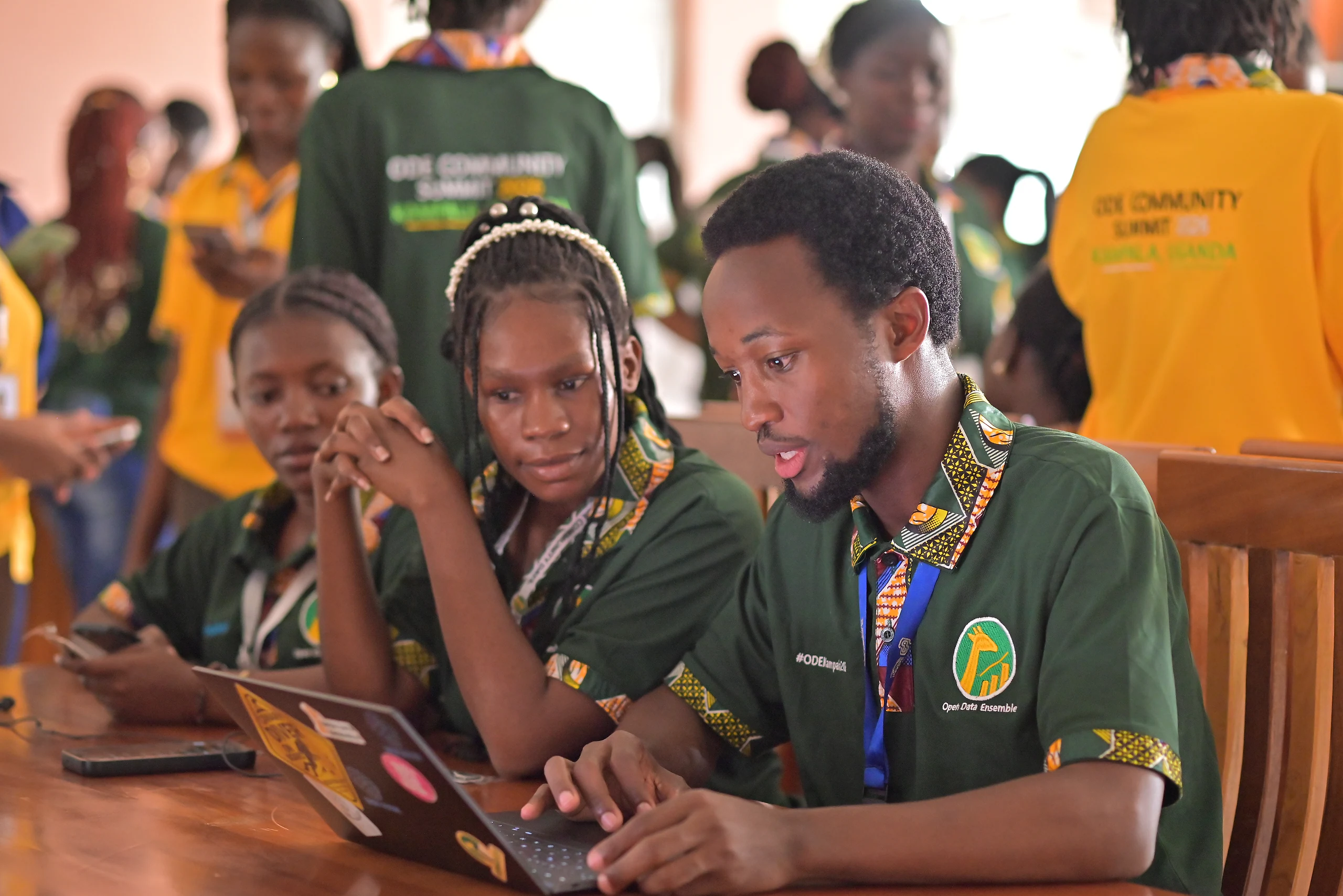 Participants work through an exercise together at a laptop.