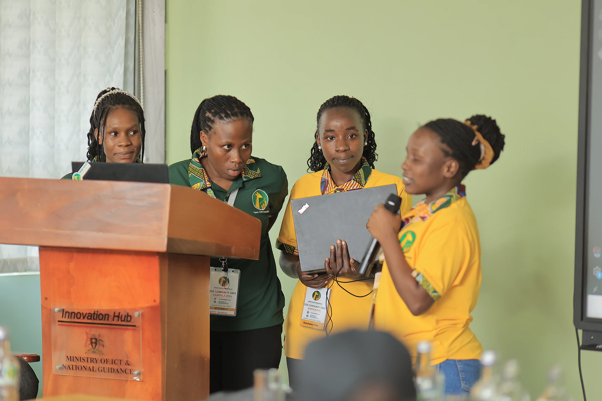 A team presents its group work from the podium.