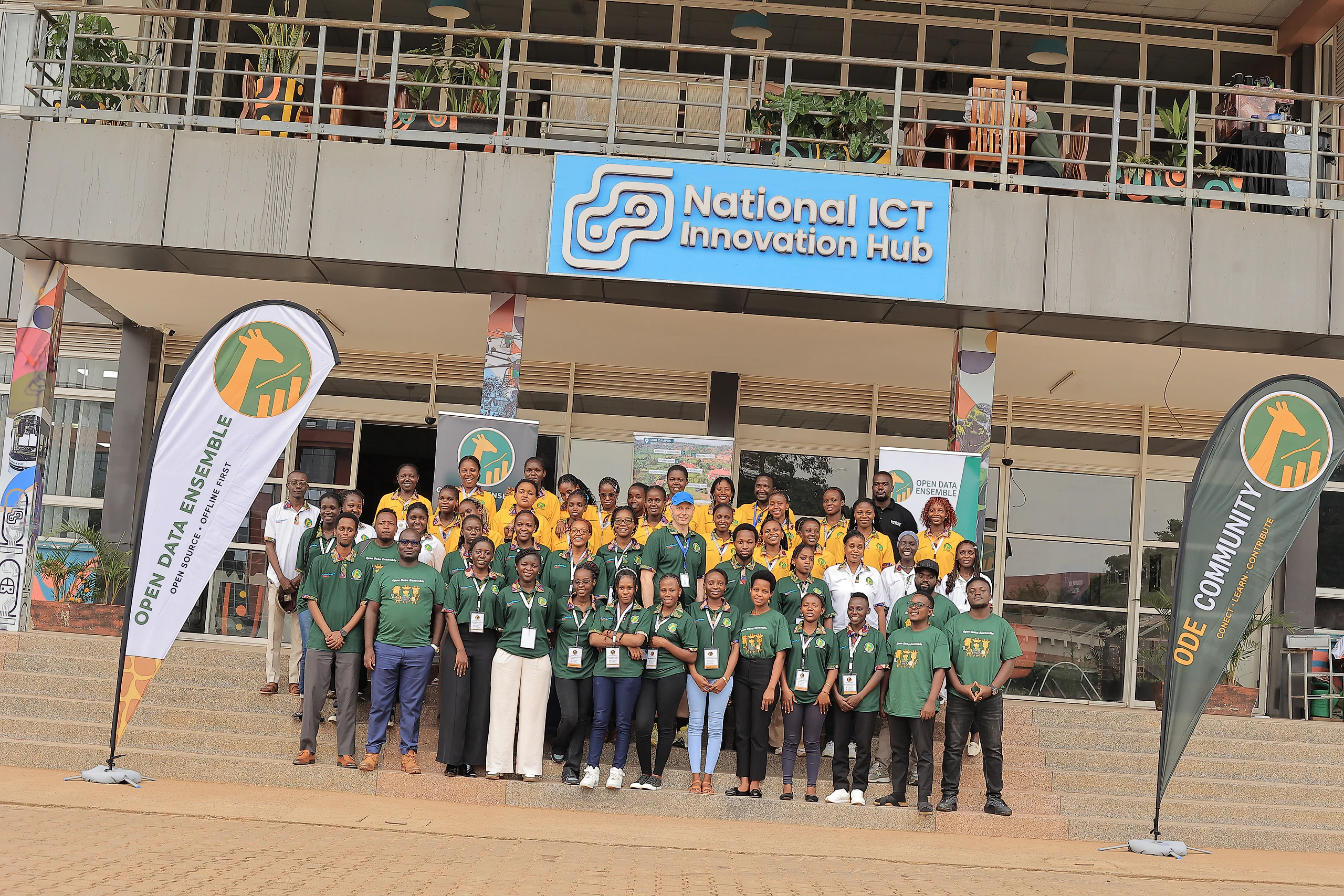 The whole group outside the National ICT Innovation Hub, between two ODE banners.